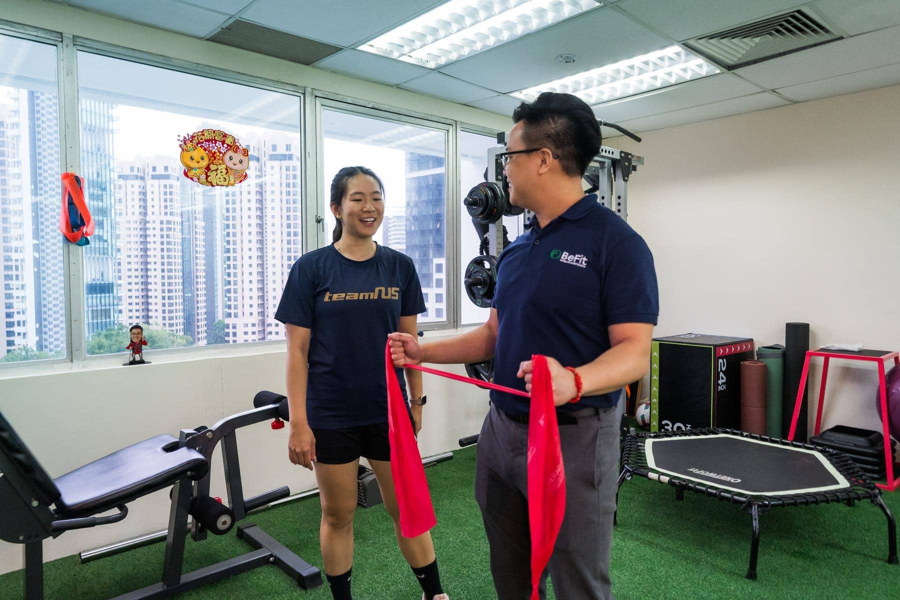 Therapist and patient during rehabilitation exercise showing supervised active treatment and progress monitoring. Demonstrates patient-centered care, exercise supervision, rehabilitation program, and therapeutic engagement. Keywords: rehabilitation exercise, supervised training, exercise program, patient supervision, active therapy, progress monitoring.